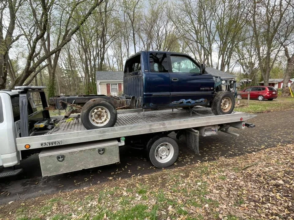 Stripped Dodge Ram missing its front clip and bed, a junk truck worth scrap weight only