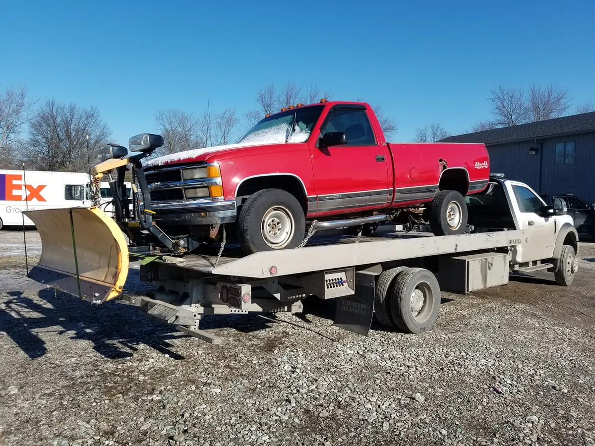 Rusted pickup truck on a flatbed, the heavy vehicle type junkyards pay the most cash for in 2026