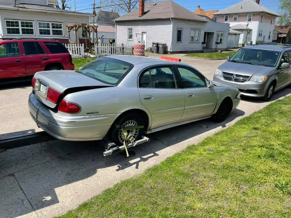 Silver Buick sedan with its trunk lid ajar during a final sweep for personal belongings before the buyer arrives