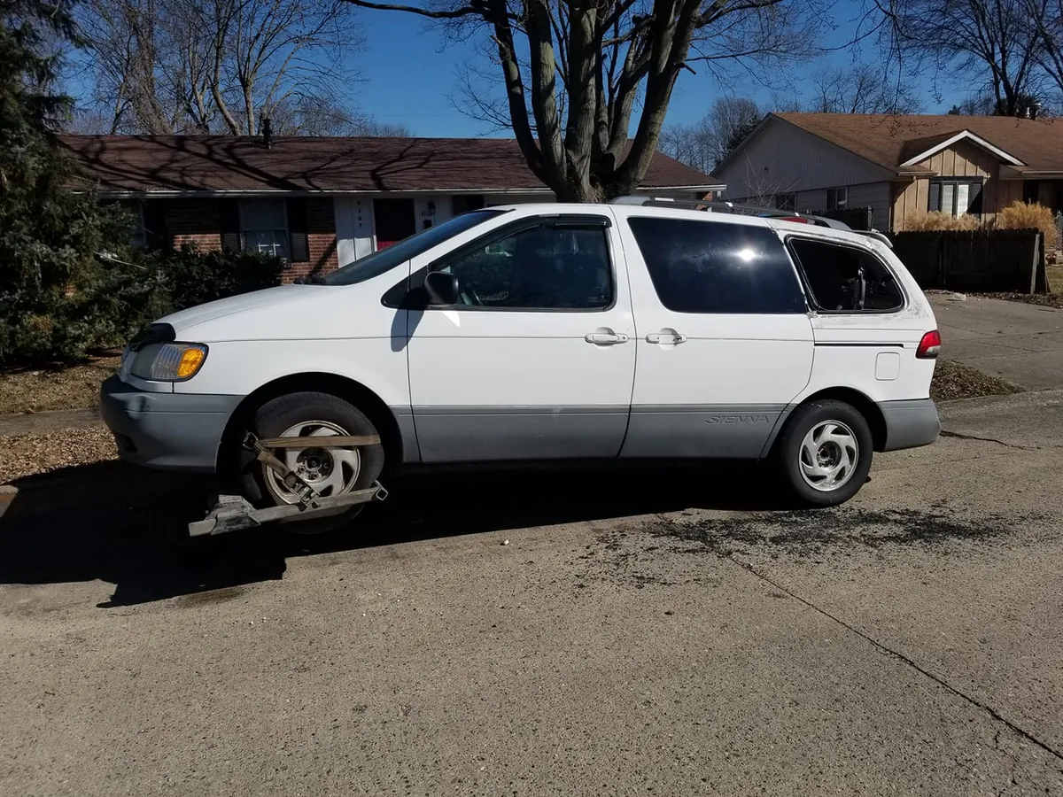 White Toyota Sienna minivan ready for junk car pickup in the Indianapolis area