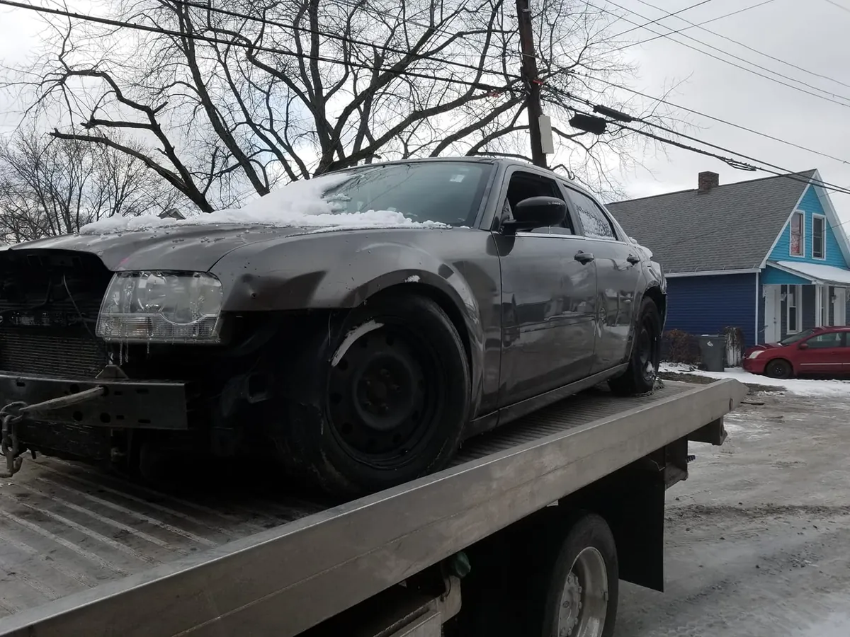 Heavily damaged sedan being evaluated for a cash offer in Indianapolis