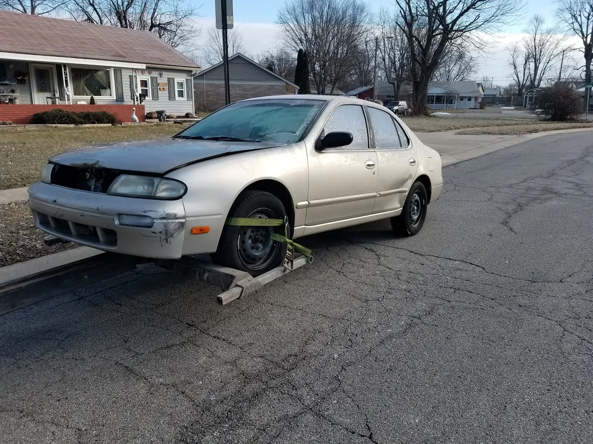 Front-end accident damage on a gold sedan -- a totaled car kept by its owner can still be sold for cash in Indiana